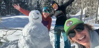 Women celebrating snowman