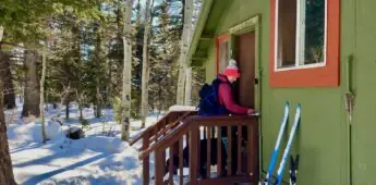 Woman entering hut